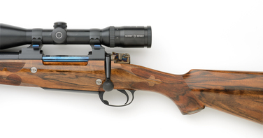  7mm left handed rifle with nitre blue bolt and color cased shroud