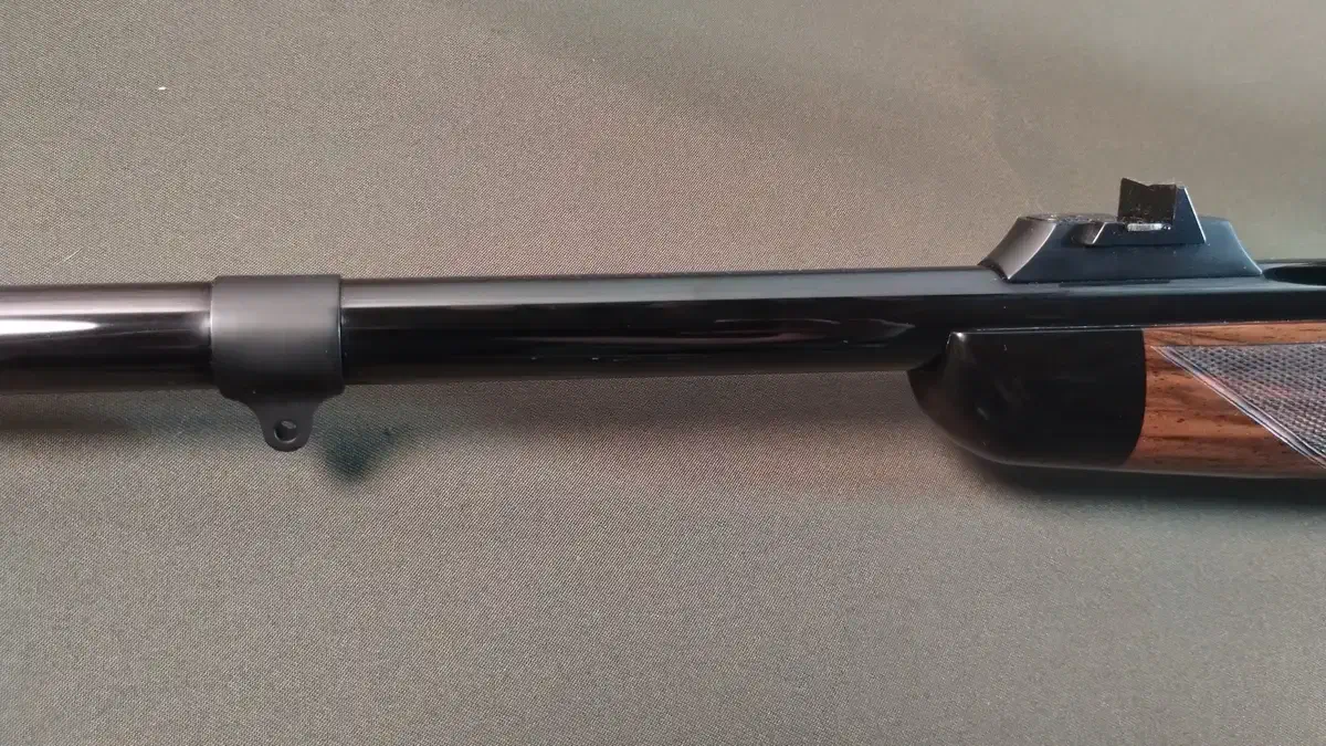 Hand-fitted barrel, quarter-rib, and open sights finished in a deep blue.